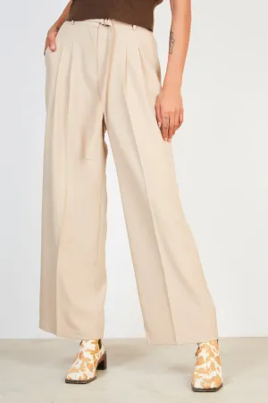 Beige pleated long belted trousers